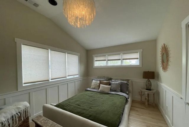 a living room with a bed furniture and a window