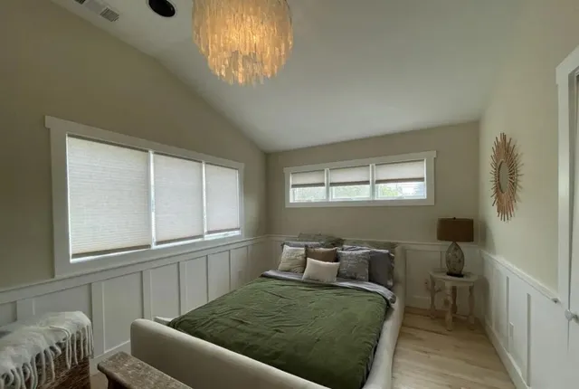 a living room with a bed furniture and a window