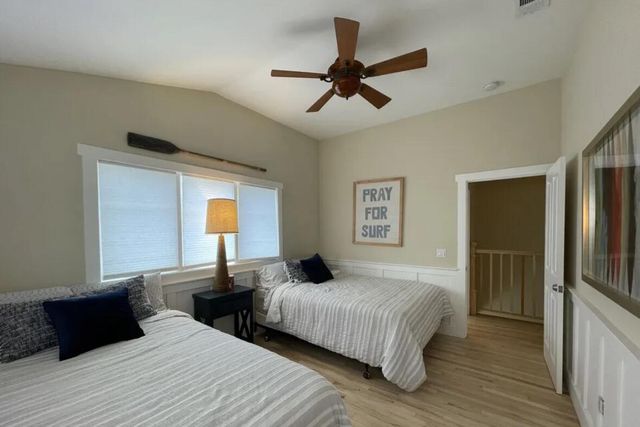 a bedroom with double bed and a large window