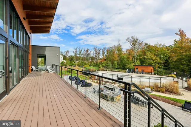 a view of a balcony with wooden floor and iron stairs