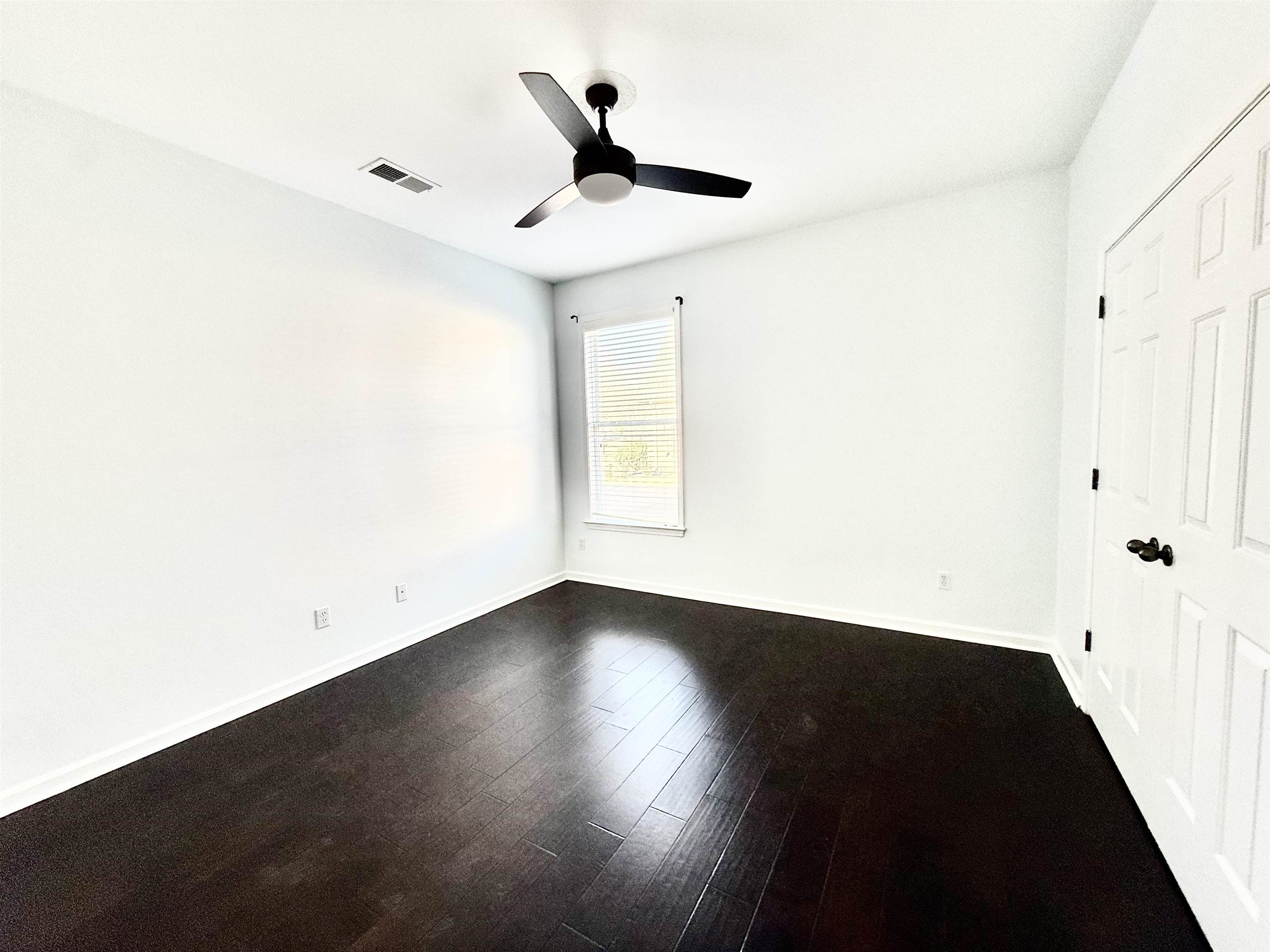 4560 Model Cove Bartlett, TN 38002 - Photo 14 of 18 an empty room with wooden floor and windows