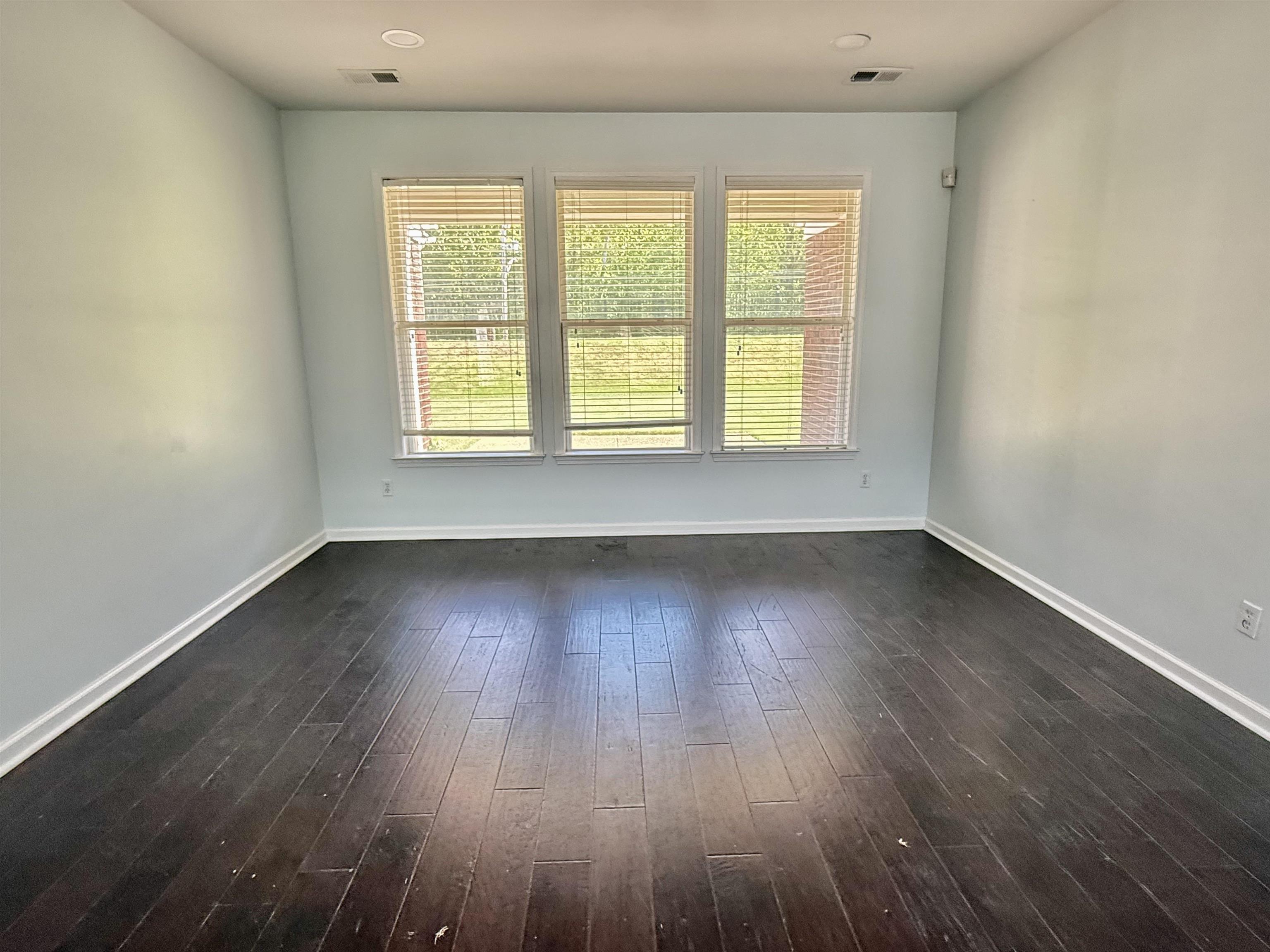 4560 Model Cove Bartlett, TN 38002 - Photo 2 of 18 an empty room with wooden floor and windows