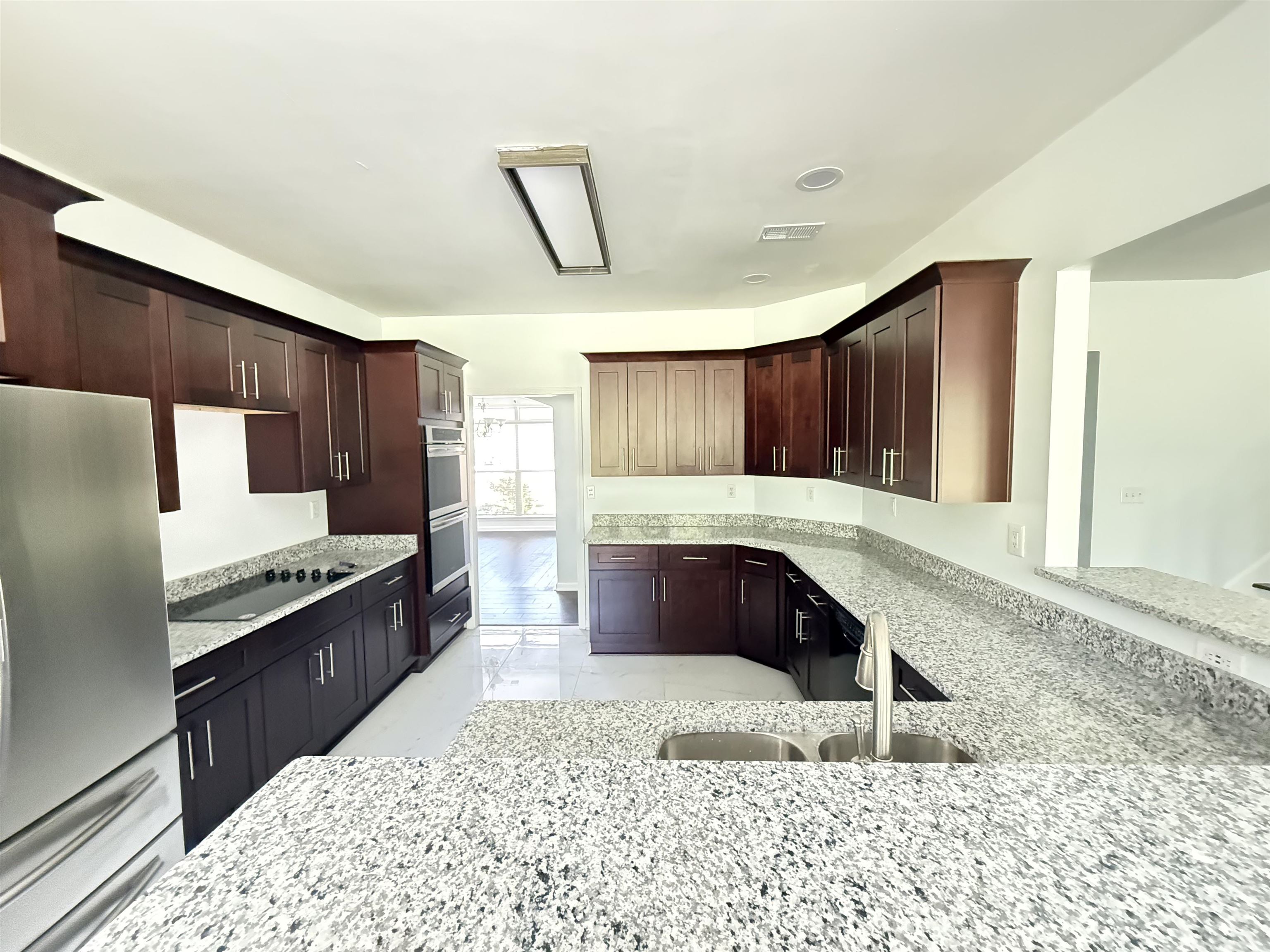 4560 Model Cove Bartlett, TN 38002 - Photo 5 of 18 a kitchen with stainless steel appliances granite countertop a stove a sink and a refrigerator