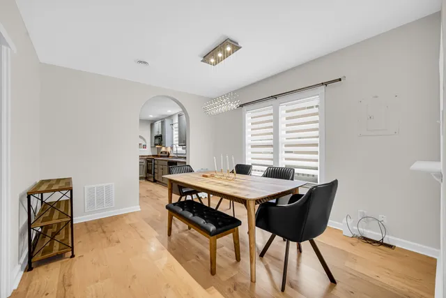 a dining room with a wooden table and chairs