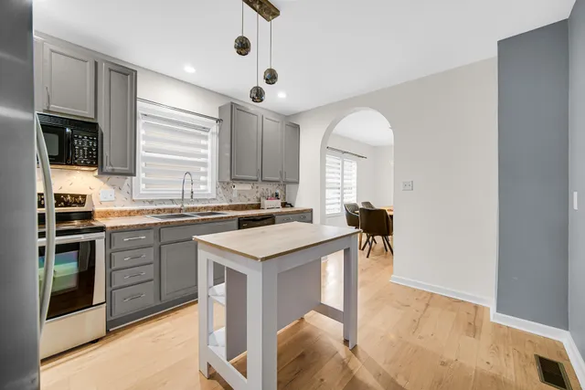 a kitchen with a sink cabinets and window