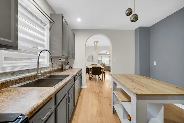 a kitchen with granite countertop a sink and stove