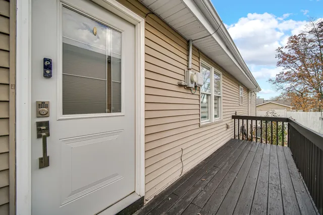 a view of a balcony with wooden floor and fence