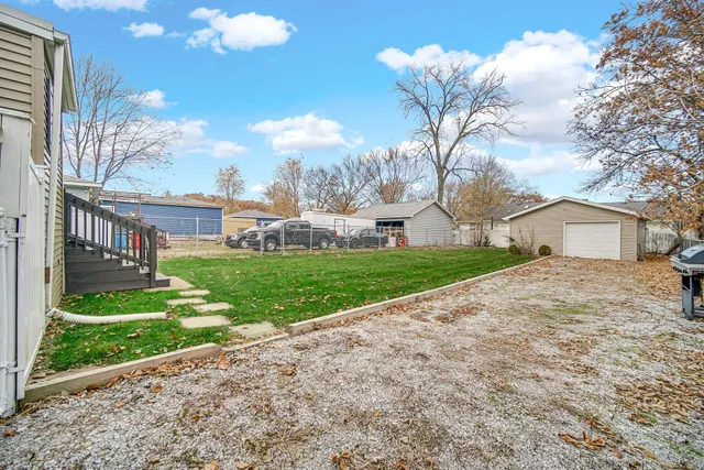 a view of a house with a big yard and large trees