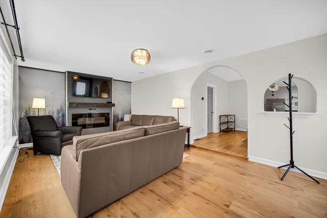a living room with furniture a flat screen tv and a fireplace