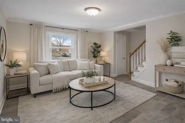 a living room with furniture a window and a dining table