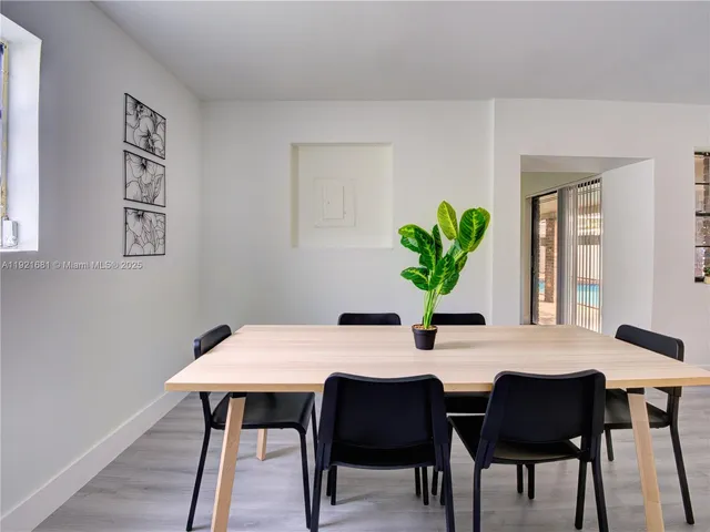 a dining room with furniture and wooden floor