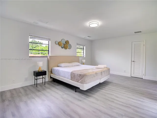 a bedroom with a bed and a chair