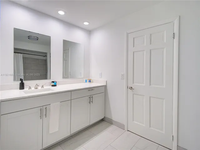 a bathroom with 2 sink and a mirror