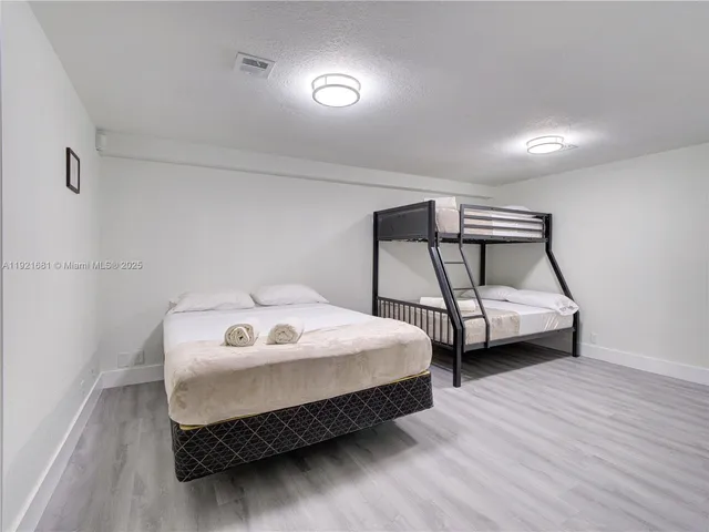 a bedroom with a bed and a small car parked