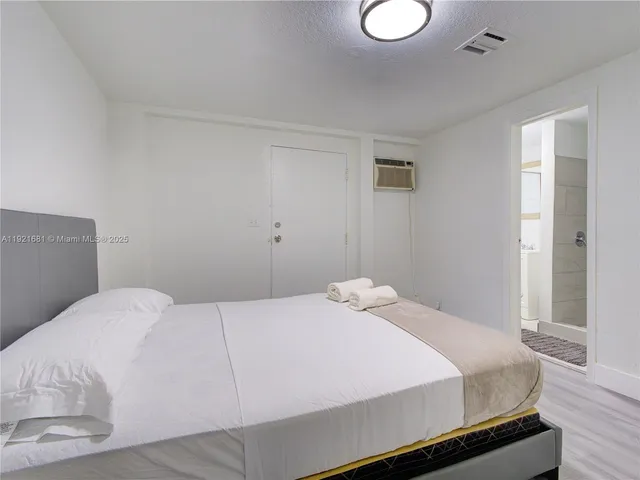 a bedroom with a bed and a lamp