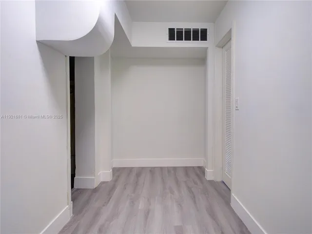 a view of a room with wooden floor