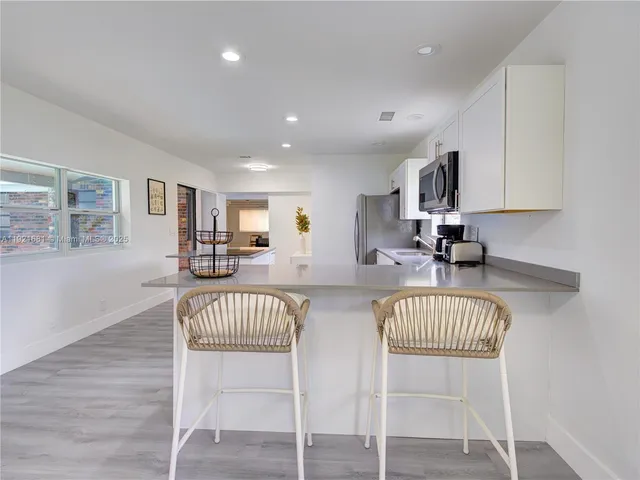 a view of kitchen with furniture and wooden floor