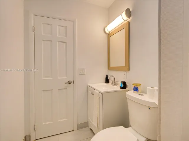 a white toilet sitting next to a bathroom sink