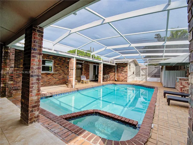 a view of a backyard with a patio and outdoor seating
