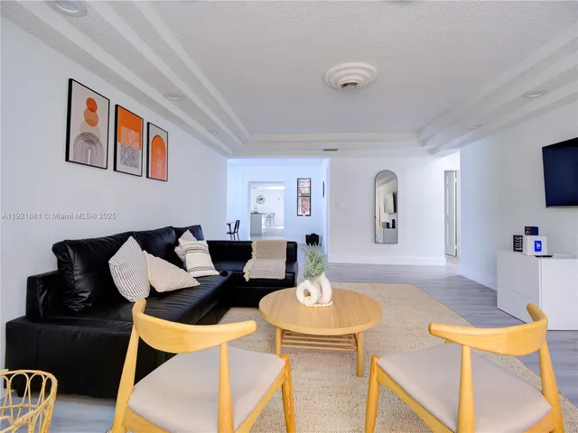 a living room with furniture and flat screen tv