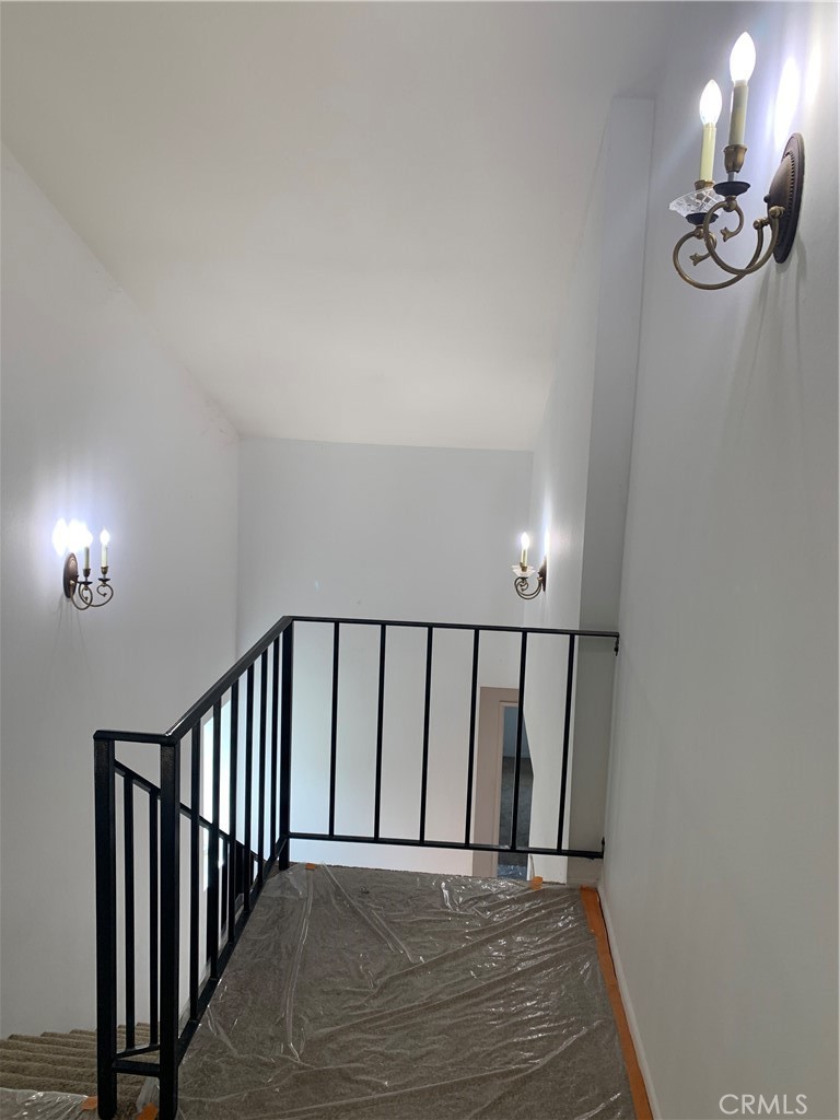 5246 Calderon Road Woodland Hills, CA 91364 - Photo 16 of 50 a view of a hallway with wooden floor and a chandelier
