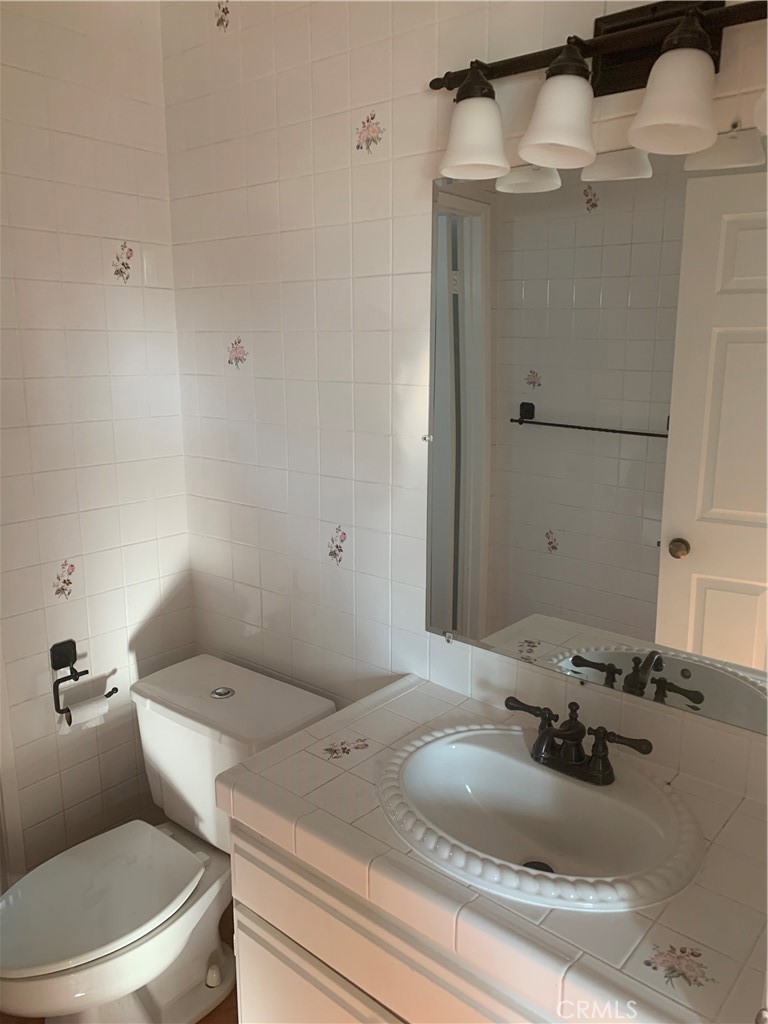 5246 Calderon Road Woodland Hills, CA 91364 - Photo 33 of 50 a bathroom with a granite countertop sink toilet and shower