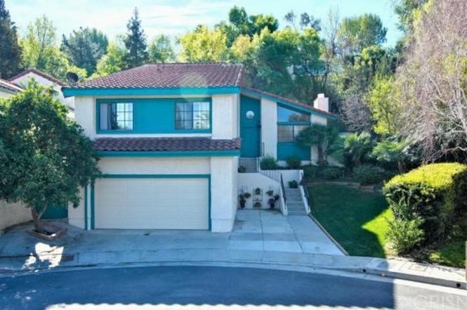 5246 Calderon Road Woodland Hills, CA 91364 - Photo 4 of 50 a front view of a house with a yard and garage