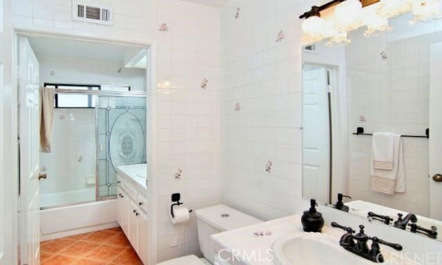 5246 Calderon Road Woodland Hills, CA 91364 - Photo 9 of 50 a bathroom with a tub sink mirror and a shower