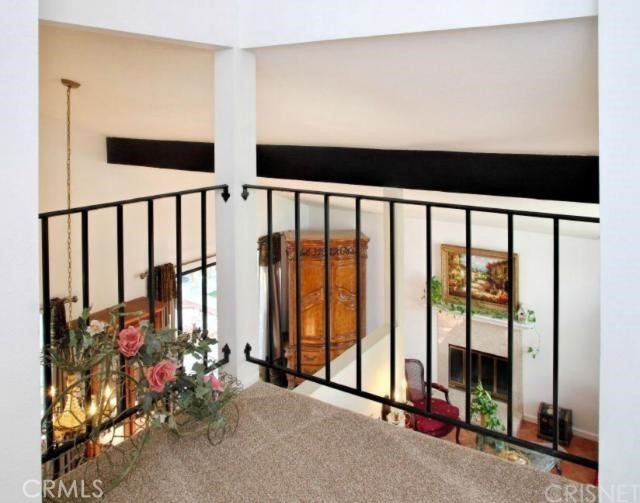 5246 Calderon Road Woodland Hills, CA 91364 - Photo 10 of 50 a view of an empty room with floor to ceiling windows and stairs