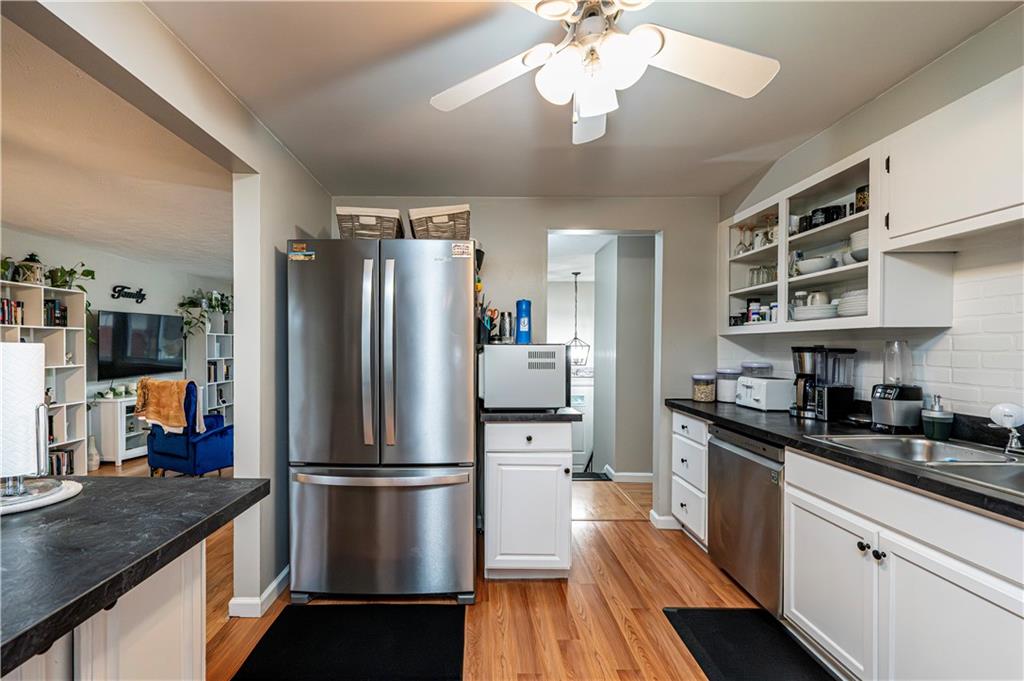 23 Seneca Drive Greensburg, PA 15601 - Photo 16 of 36 a kitchen with stainless steel appliances granite countertop a refrigerator a stove a sink dishwasher and a refrigerator with wooden floor