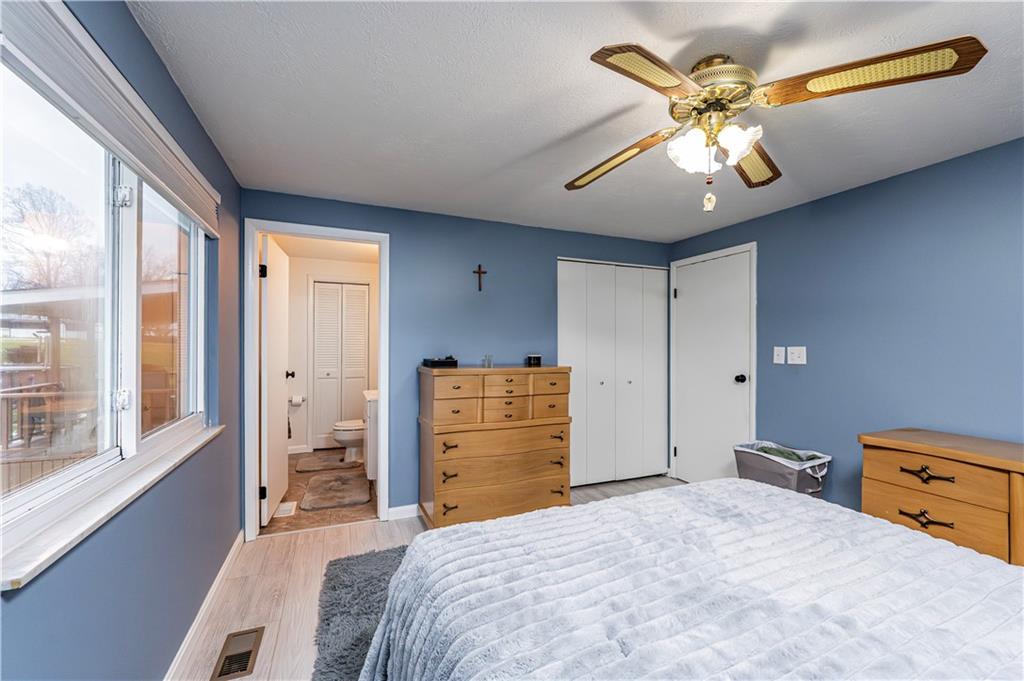 23 Seneca Drive Greensburg, PA 15601 - Photo 25 of 36 a bedroom with a bed and a chandelier