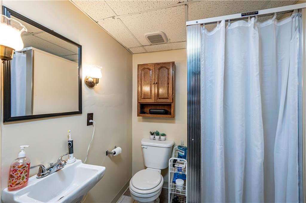 23 Seneca Drive Greensburg, PA 15601 - Photo 34 of 36 a bathroom with a sink a toilet and shower curtain