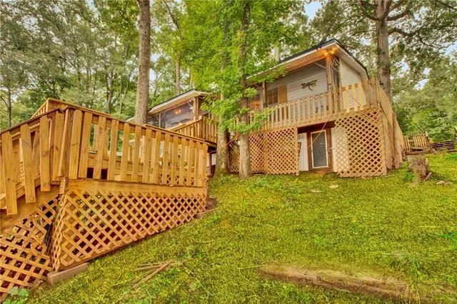 a view of a house with a wooden fence