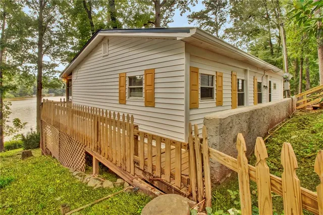 a view of a house with wooden fence