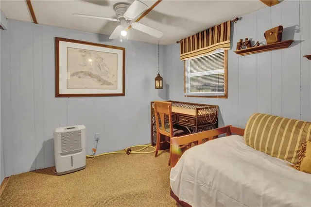 a bedroom with bed and wooden floor