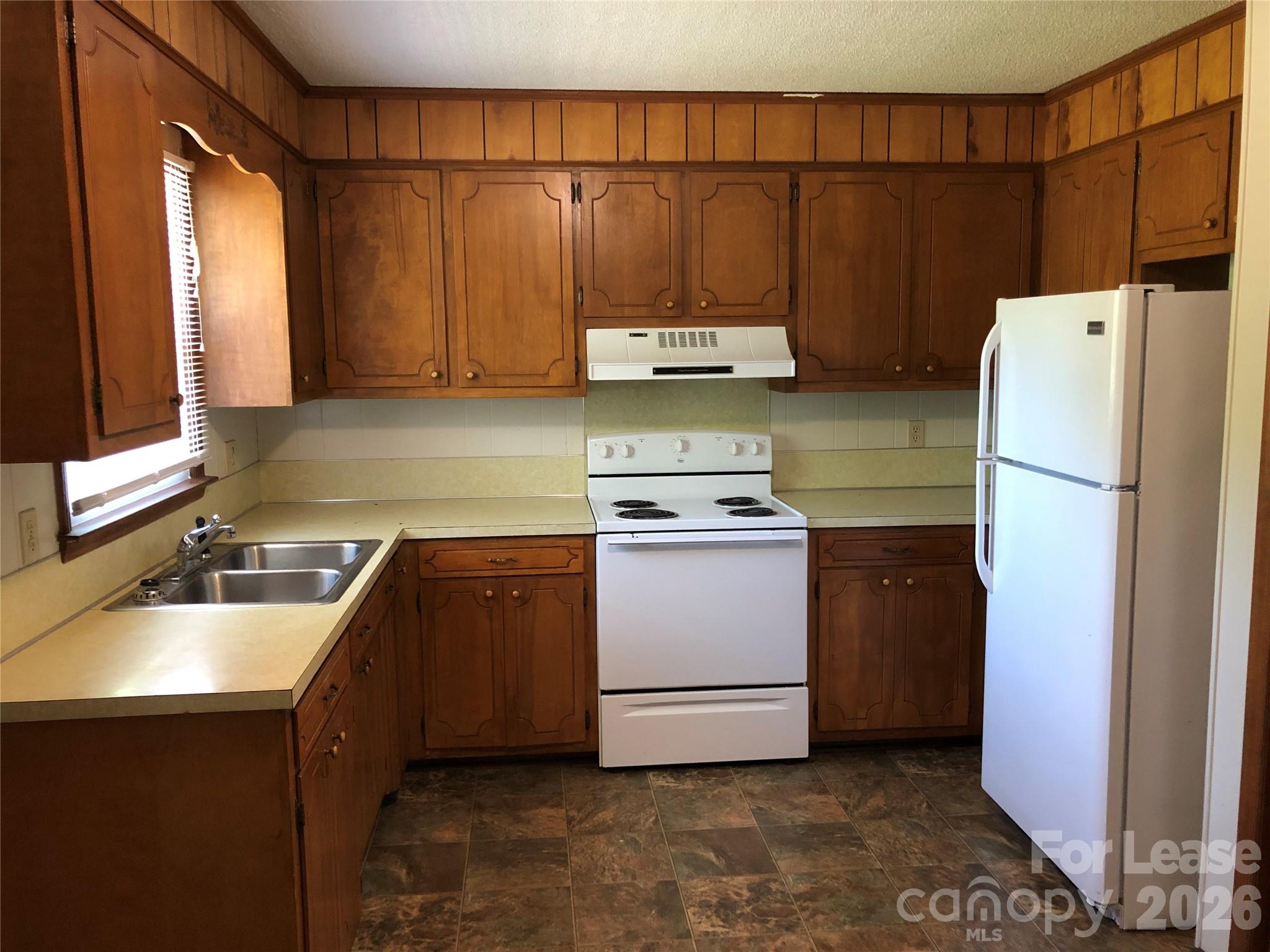 1411 Roundtree Lane, Unit 132 Lincolnton, NC 28092 - Photo 3 of 7 a kitchen with a refrigerator and a sink