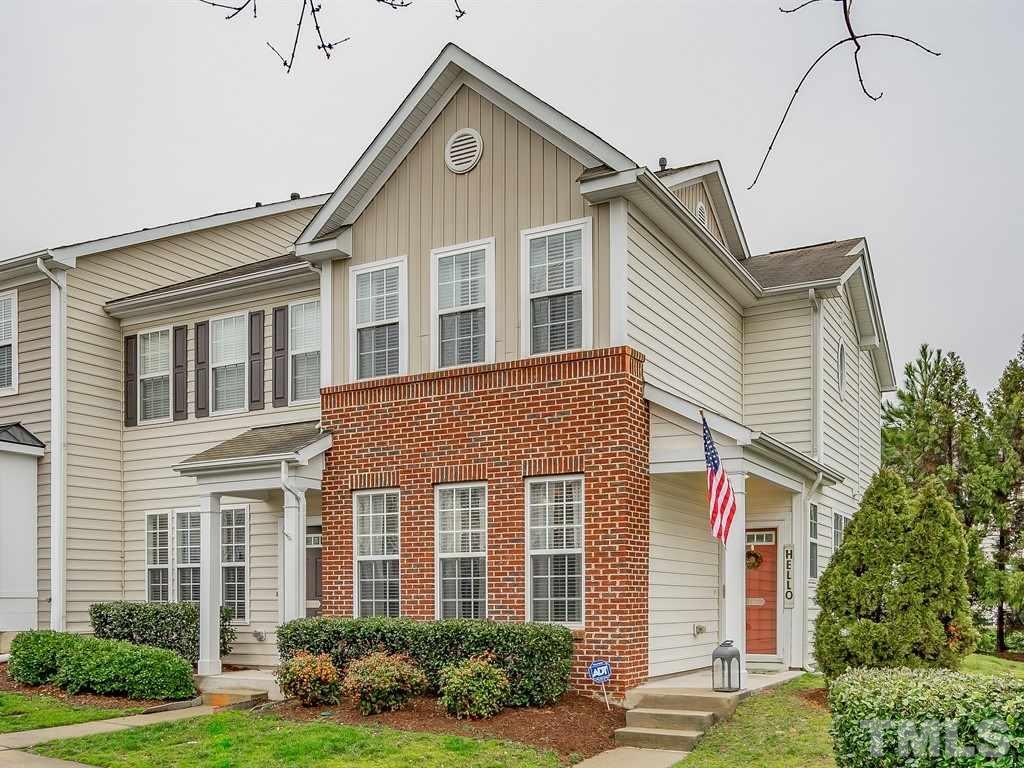 7865 Spungold Street Raleigh, NC 27617 - Photo 1 of 15 a front view of a house with a yard and garage