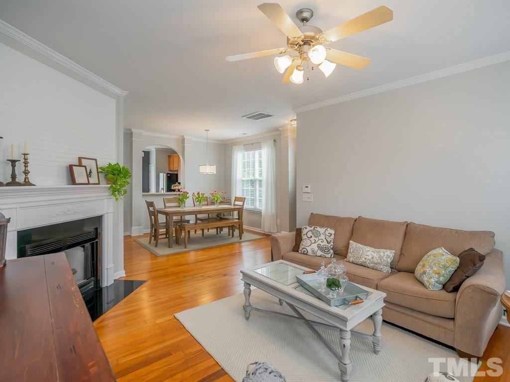7865 Spungold Street Raleigh, NC 27617 - Photo 3 of 15 a living room with furniture and a fireplace