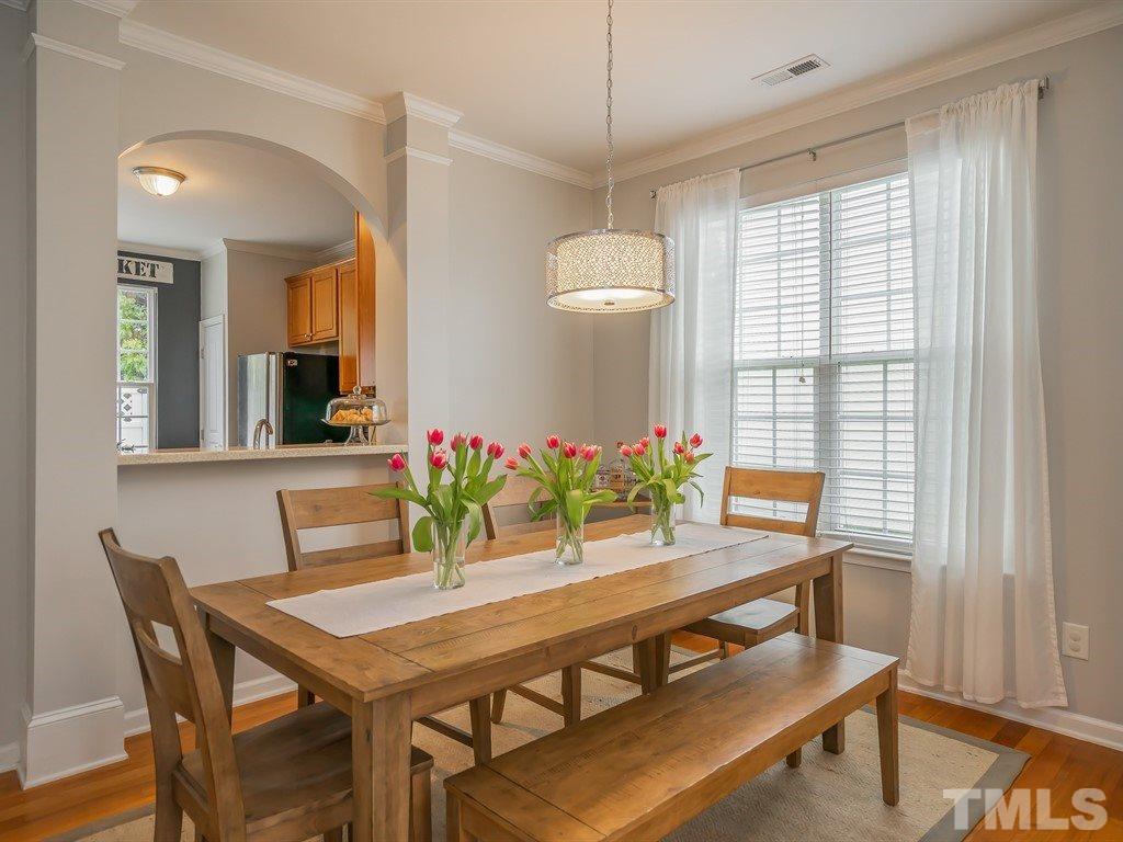 7865 Spungold Street Raleigh, NC 27617 - Photo 5 of 15 a view of a dining room with furniture and window