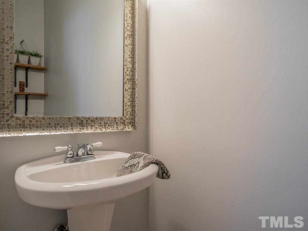 7865 Spungold Street Raleigh, NC 27617 - Photo 6 of 15 a bathroom with a sink and a mirror