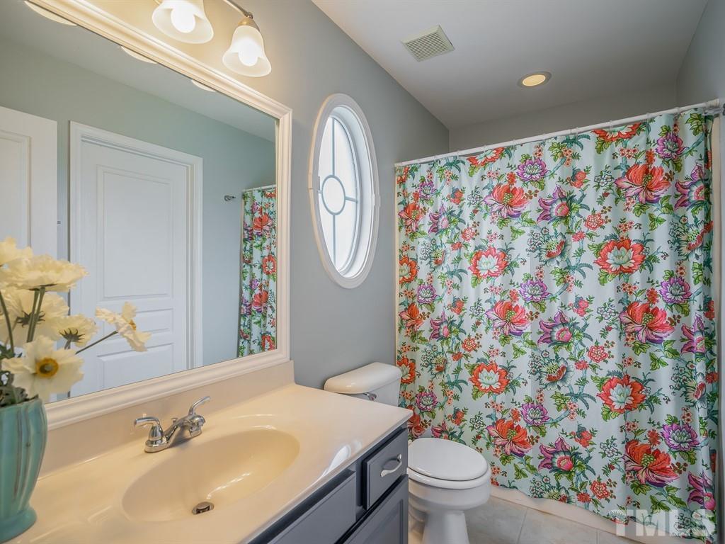 7865 Spungold Street Raleigh, NC 27617 - Photo 10 of 15 a bathroom with a sink toilet and mirror