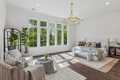 a spacious bedroom with bed and a large window