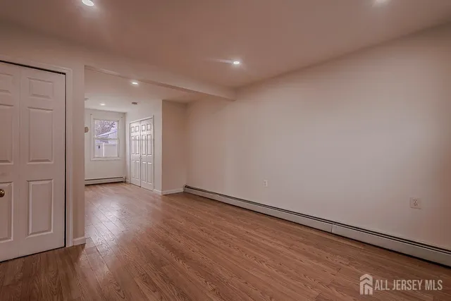 a view of an empty room and wooden floor