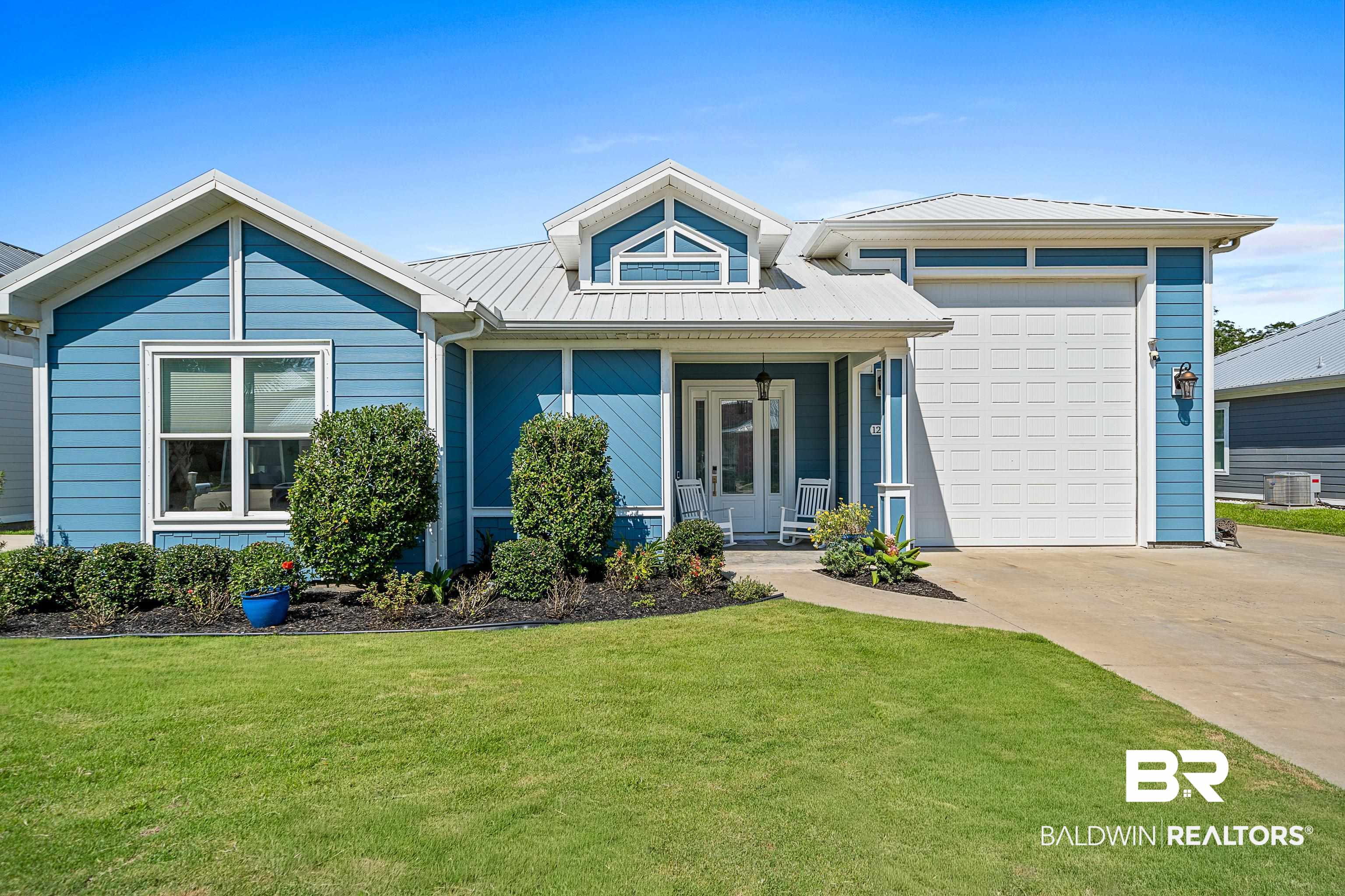 12329 Reunion Place, Unit LOT 38 Foley, AL 36535 - Photo 2 of 43 View of front of house with a metal roof, a porch, concrete driveway, a garage, and a front lawn