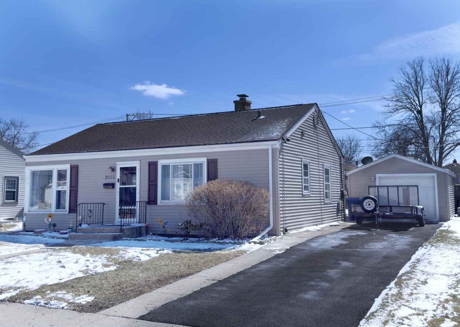 2035 Fargo Street Des Plaines, IL 60018 - Photo 3 of 19 a front view of a house with a garden