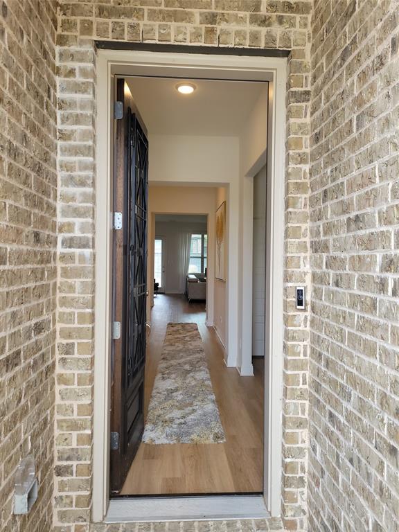 7024 Tree Stand Point Little Elm, TX 76227 - Photo 3 of 30 a view of a hallway with a door and couch