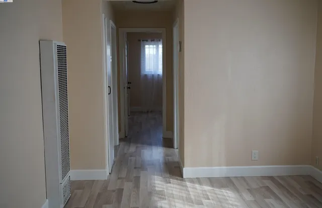 a view of a hallway with wooden floor