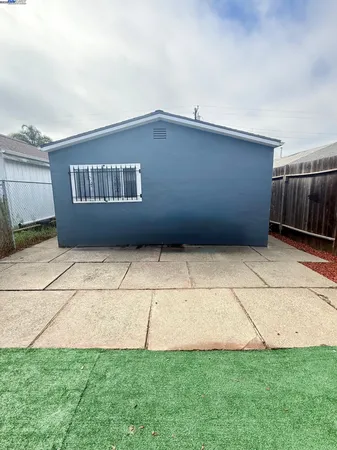 a view of backyard with wooden fence