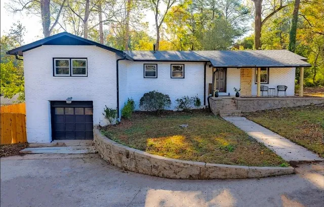a view of a house with swimming pool and a yard