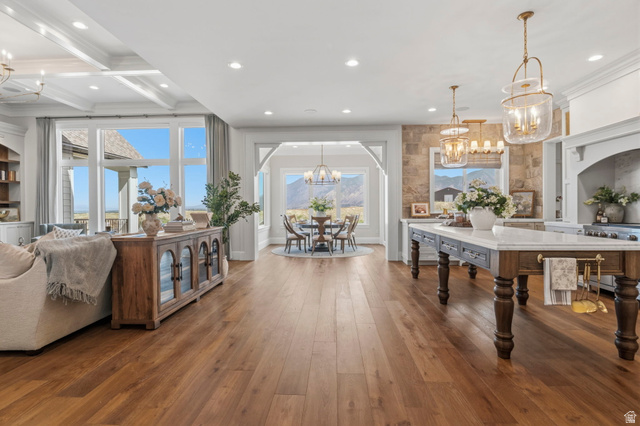 115 East Hidden Ridge Lane, Unit 42 Mapleton, UT 84664 - Photo 7 of 103 Expansive living area featuring wide plank wood-finish flooring, a coffered ceiling, and large windows